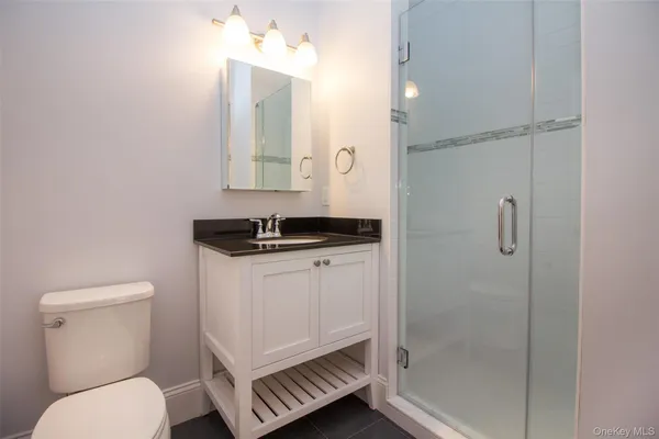 a bathroom with a toilet sink and shower