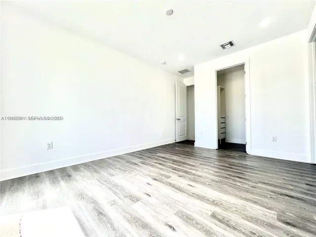 a view of a room with wooden floor