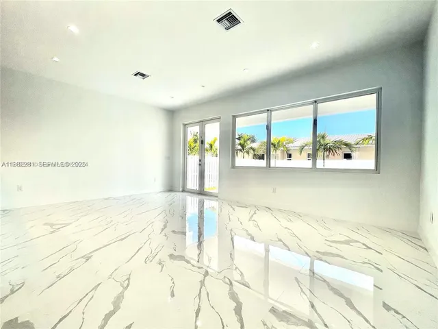 a view of a room with window and natural light