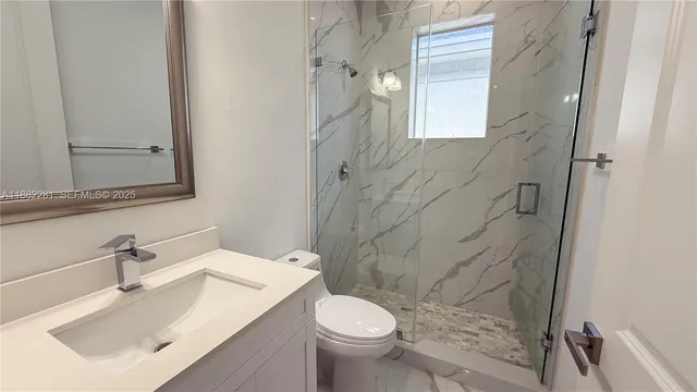 a bathroom with a sink toilet and shower