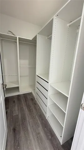a view of walk in closet with empty racks