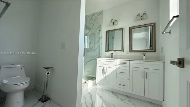 a spacious bathroom with a toilet sink and mirror
