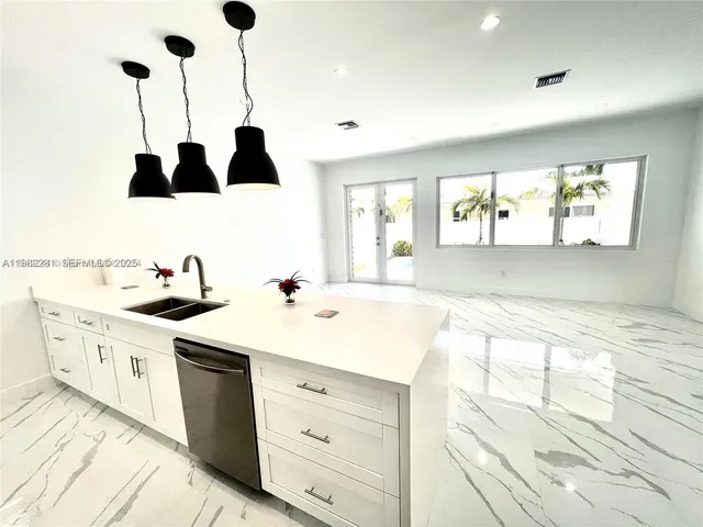 a kitchen with a sink cabinets and window