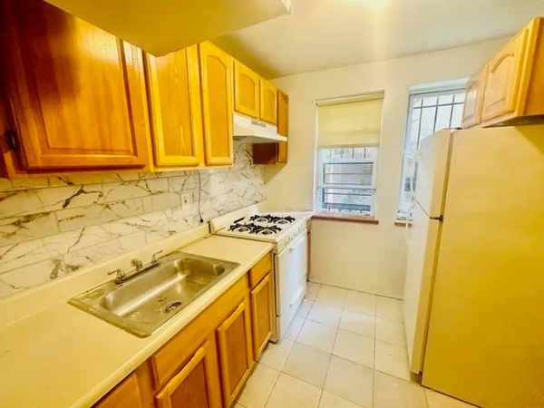 a kitchen with a stove a sink and a refrigerator