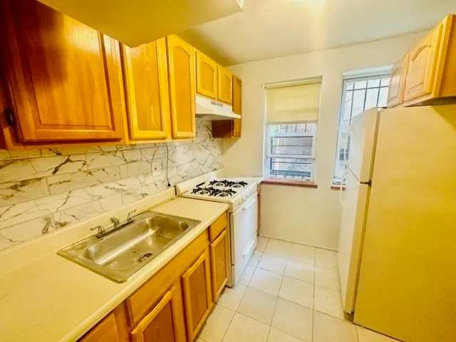 a kitchen with a stove a sink and a refrigerator