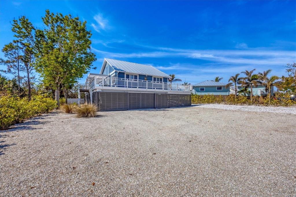 331 Bocilla Drive Boca Grande, FL 33921 - Photo 6 of 34 a front view of a house with a yard and a large tree