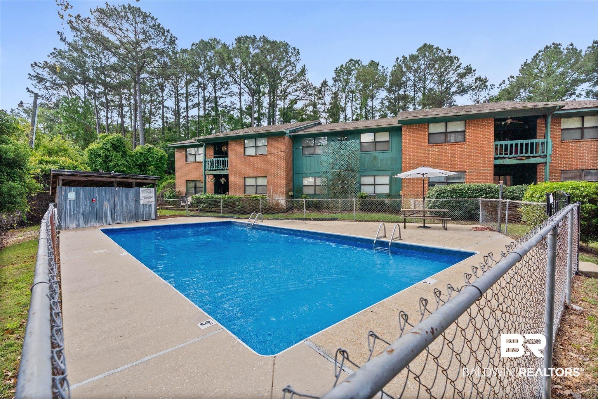 500 Grant Street, Unit D213 Daphne, AL 36526 - Photo 6 of 6 Fenced in-ground swimming pool with concrete surround