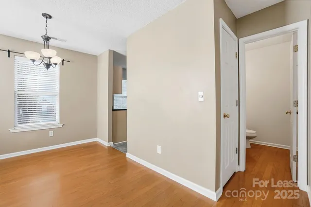 a view of livingroom with hardwood floor and a hallway