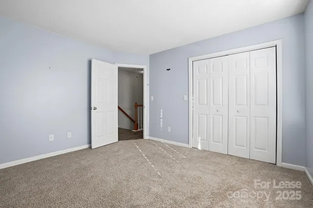 a view of an empty room and closet area