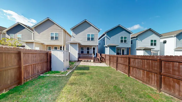 a view of house with yard outdoor seating and barbeque oven