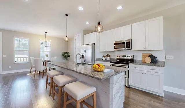 a kitchen with a sink a counter top space appliances and cabinets