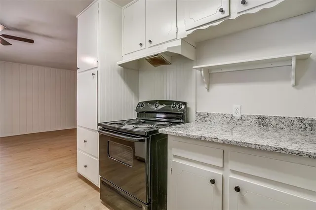 a stove top oven sitting inside of a kitchen