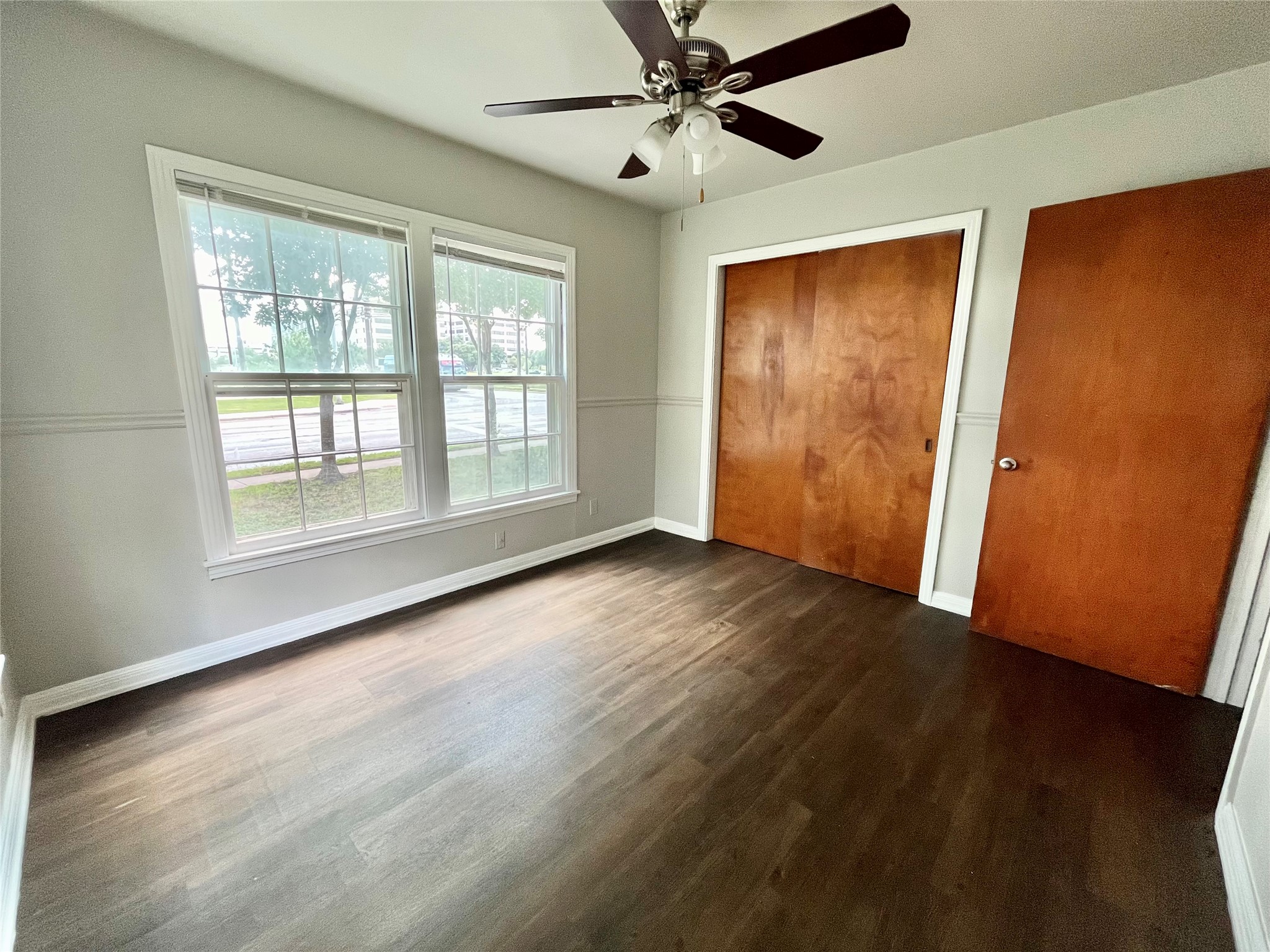5101 Guadalupe Street, Unit A Austin, TX 78751 - Photo 13 of 28 Unfurnished bedroom featuring a closet, dark wood-type flooring, and a ceiling fan