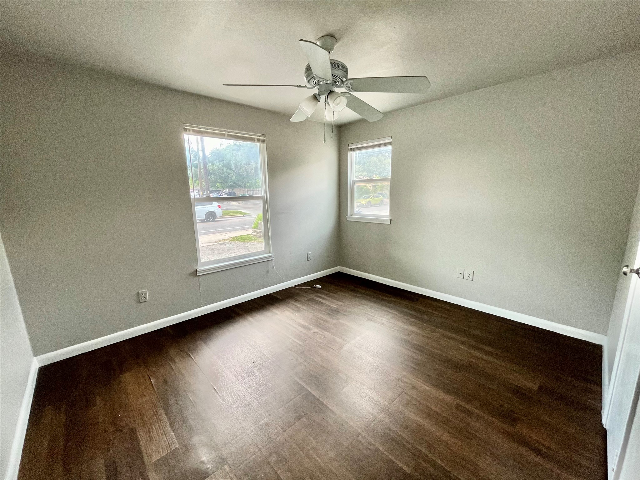 5101 Guadalupe Street, Unit A Austin, TX 78751 - Photo 13 of 28 an empty room with wooden floor chandelier fan and windows