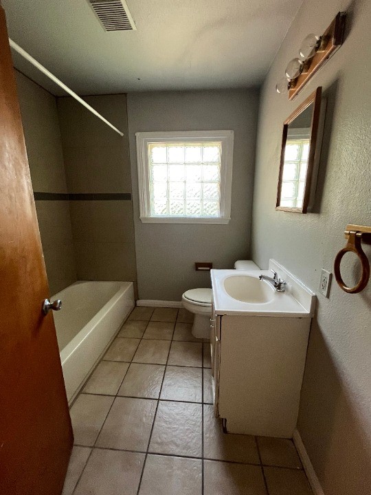 5101 Guadalupe Street, Unit A Austin, TX 78751 - Photo 14 of 28 a bathroom with a sink a toilet and shower