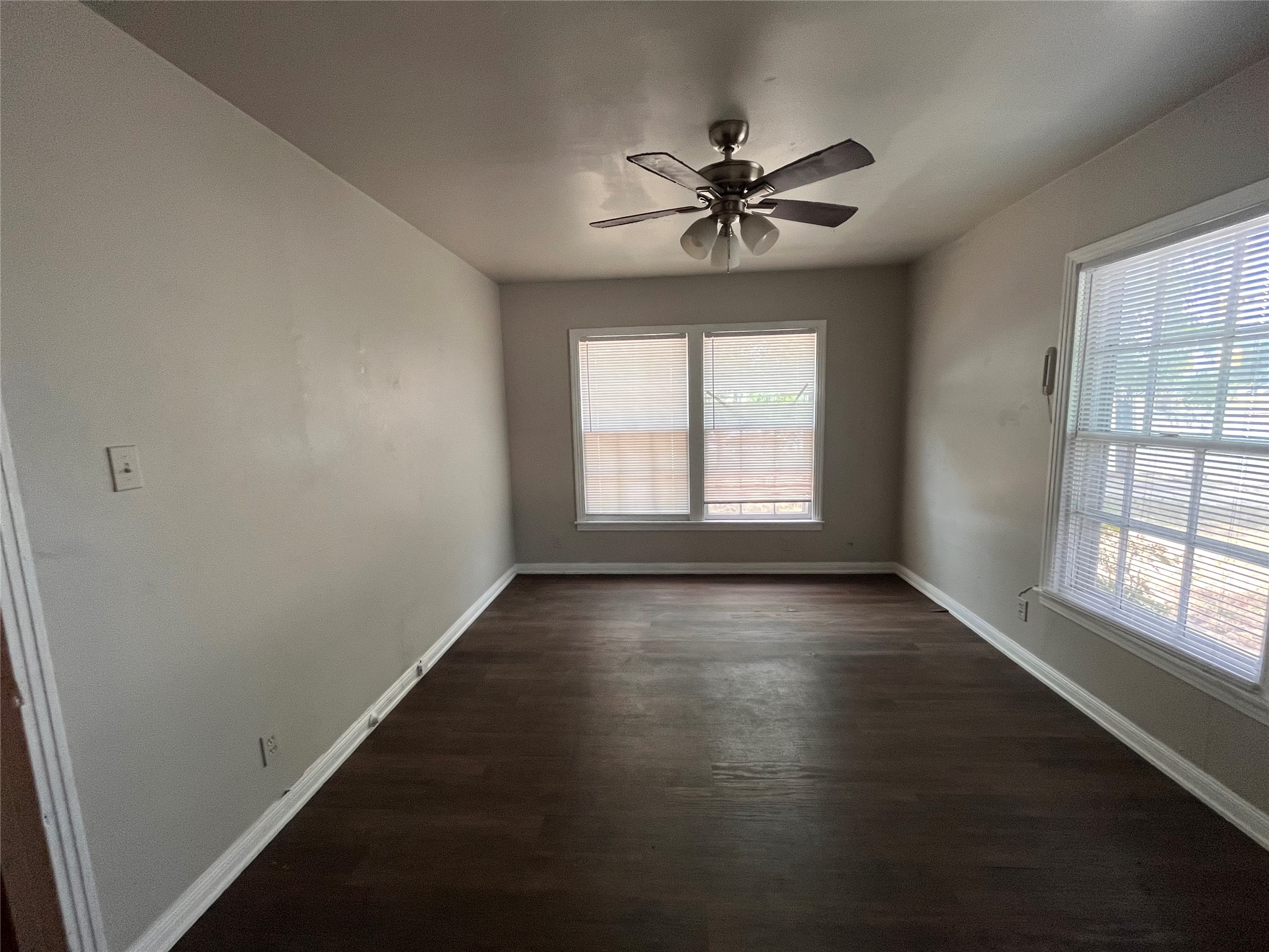 5101 Guadalupe Street, Unit A Austin, TX 78751 - Photo 17 of 28 Unfurnished room featuring a ceiling fan and dark wood finished floors