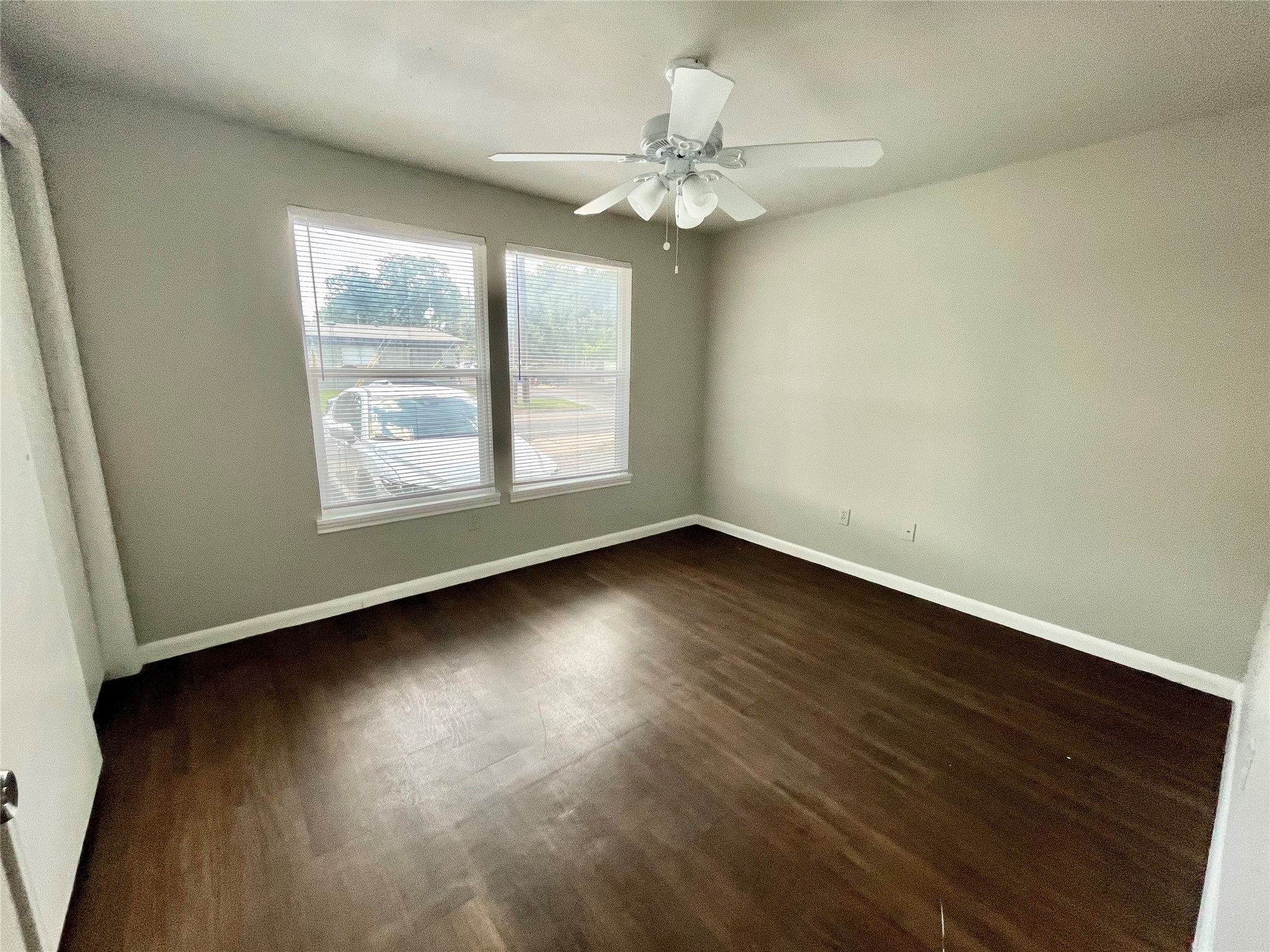 5101 Guadalupe Street, Unit A Austin, TX 78751 - Photo 20 of 28 Empty room with dark wood-style flooring and ceiling fan
