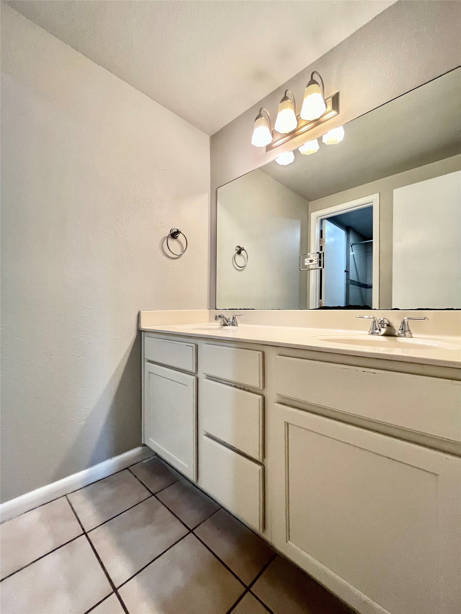 5101 Guadalupe Street, Unit A Austin, TX 78751 - Photo 21 of 28 Full bath featuring double vanity and light tile patterned floors