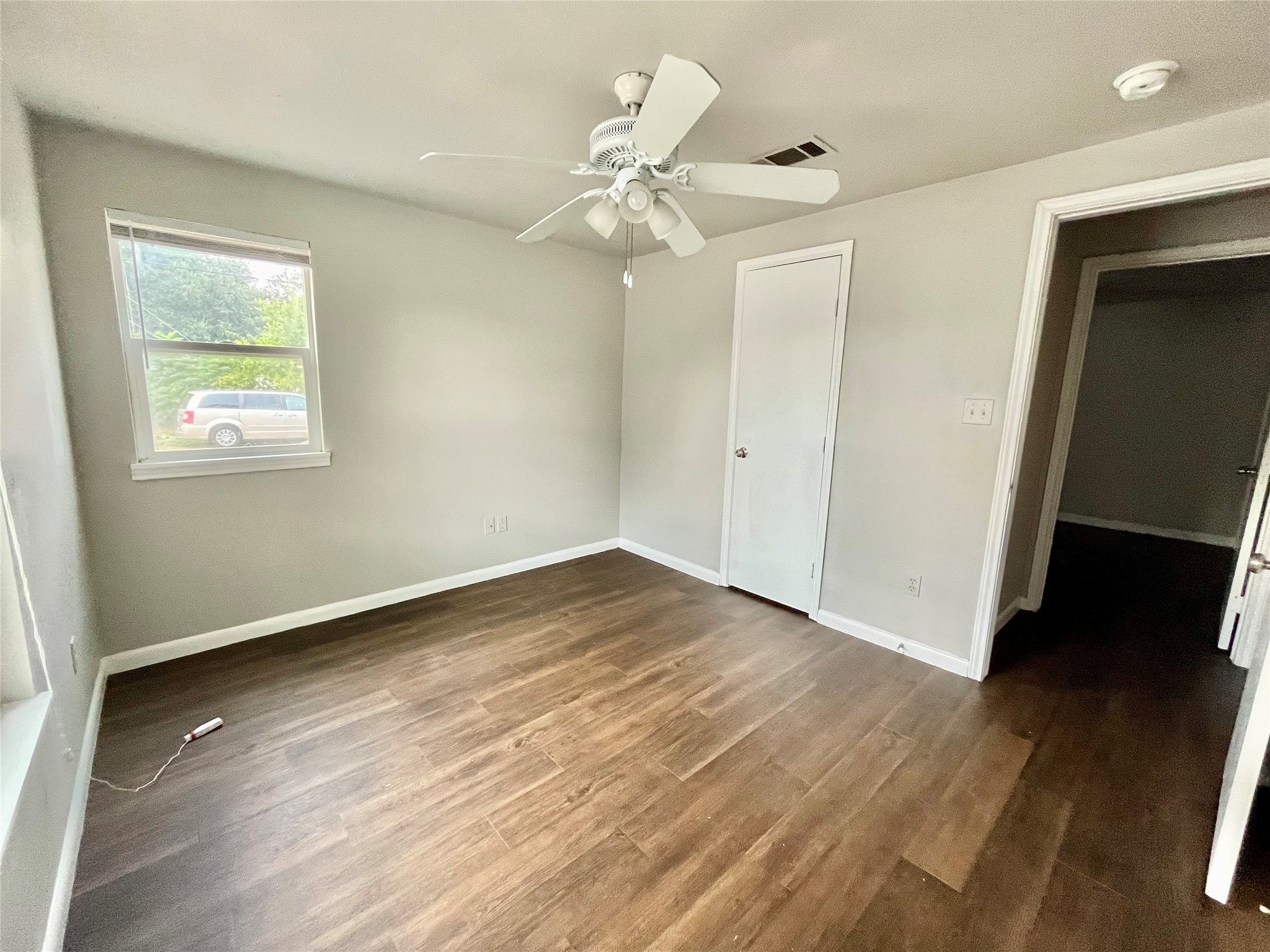 5101 Guadalupe Street, Unit A Austin, TX 78751 - Photo 23 of 28 Unfurnished bedroom featuring dark wood-type flooring and a ceiling fan