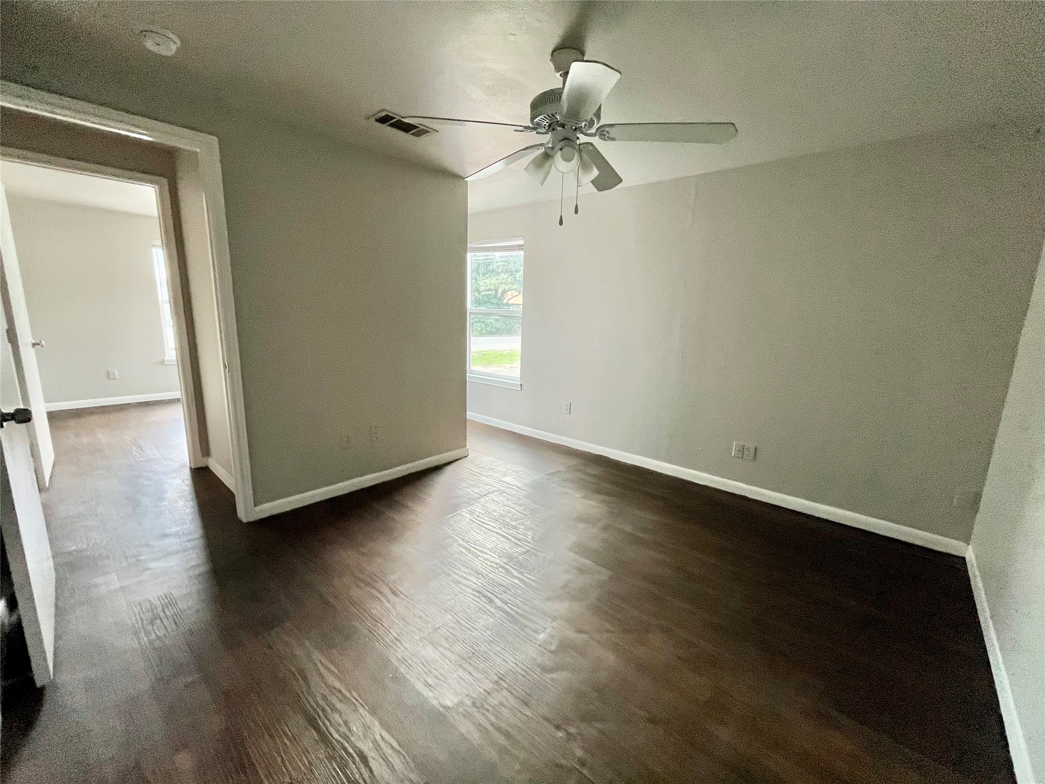 5101 Guadalupe Street, Unit A Austin, TX 78751 - Photo 24 of 28 Spare room featuring dark wood finished floors, a ceiling fan, and a smoke detector