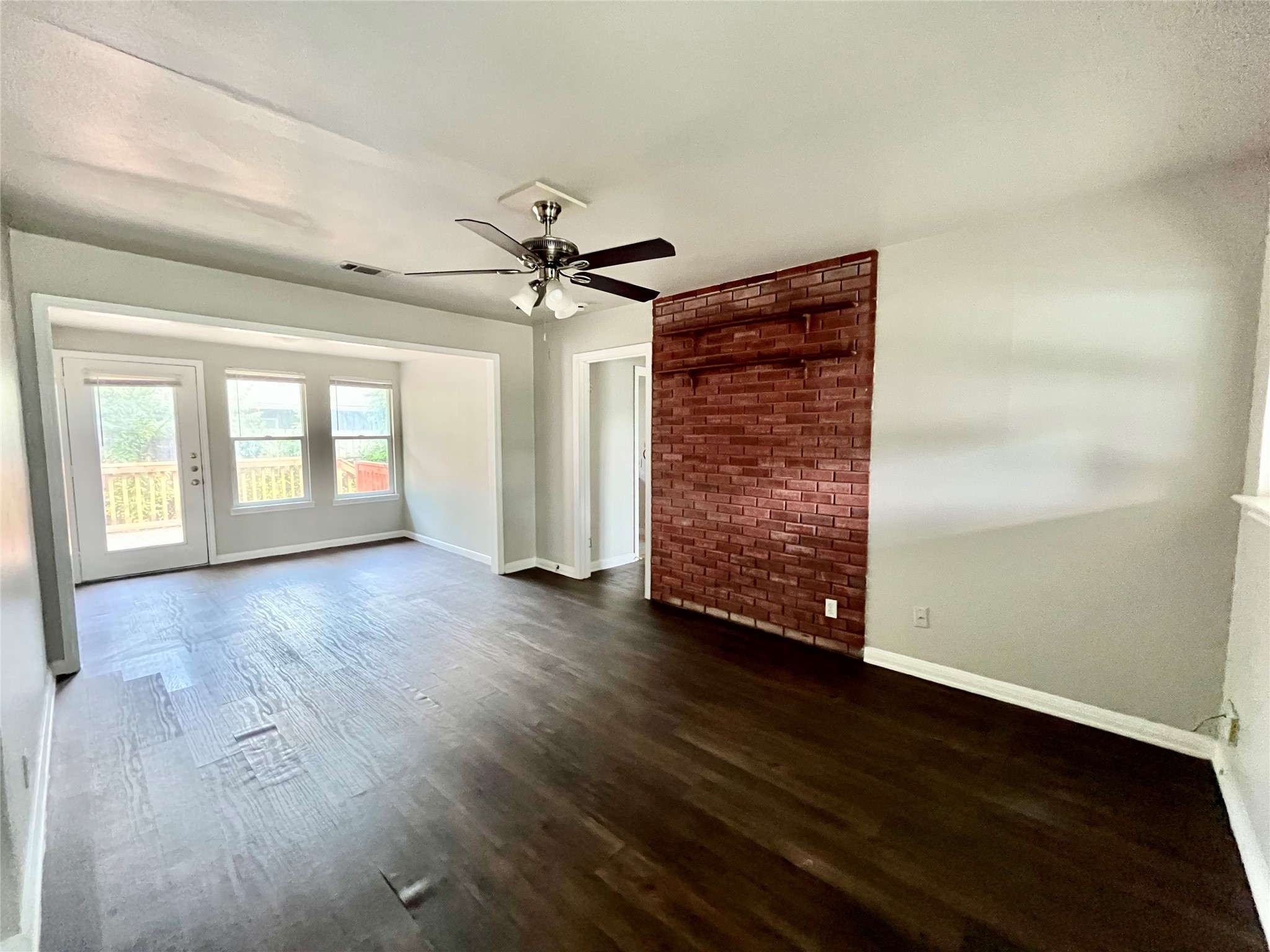 5101 Guadalupe Street, Unit A Austin, TX 78751 - Photo 5 of 28 Spare room featuring a ceiling fan and dark wood finished floors