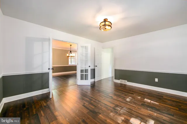 a kitchen with stainless steel appliances granite countertop wooden cabinets a stove and a wooden floors