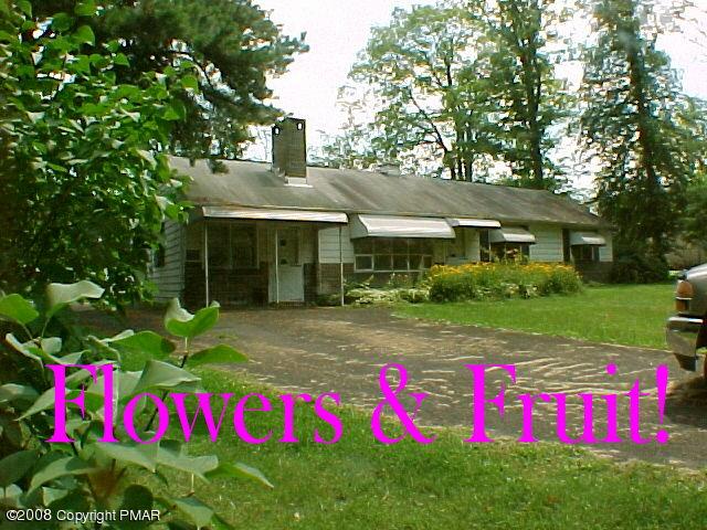 68 Woodland Road Mount Pocono, PA 18344 - Photo 2 of 11 a view of a house with pool and garden