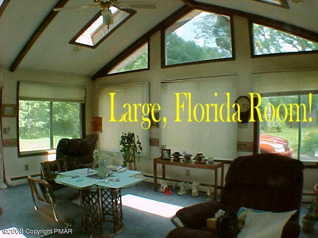 68 Woodland Road Mount Pocono, PA 18344 - Photo 3 of 11 a living room with furniture and a large window