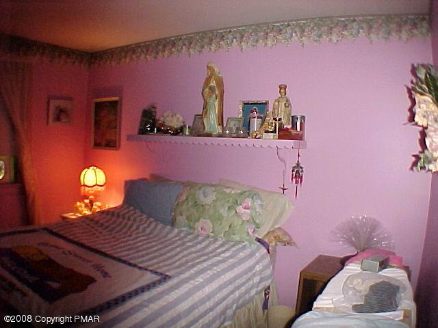 68 Woodland Road Mount Pocono, PA 18344 - Photo 10 of 11 a bedroom with a bed and a lamp with window