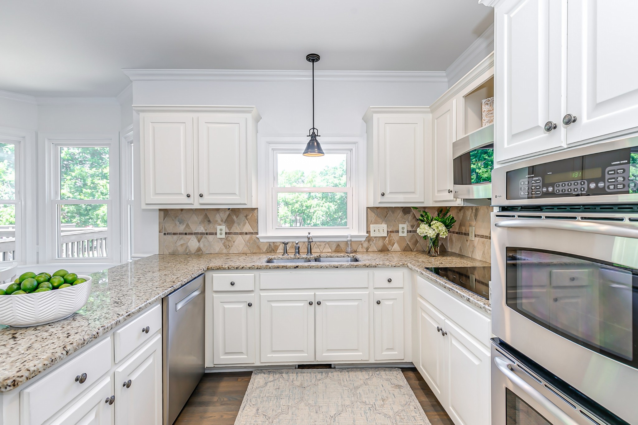 8204 Alamo Road Brentwood, TN 37027 - Photo 11 of 41 a kitchen with granite countertop white cabinets white appliances and a window