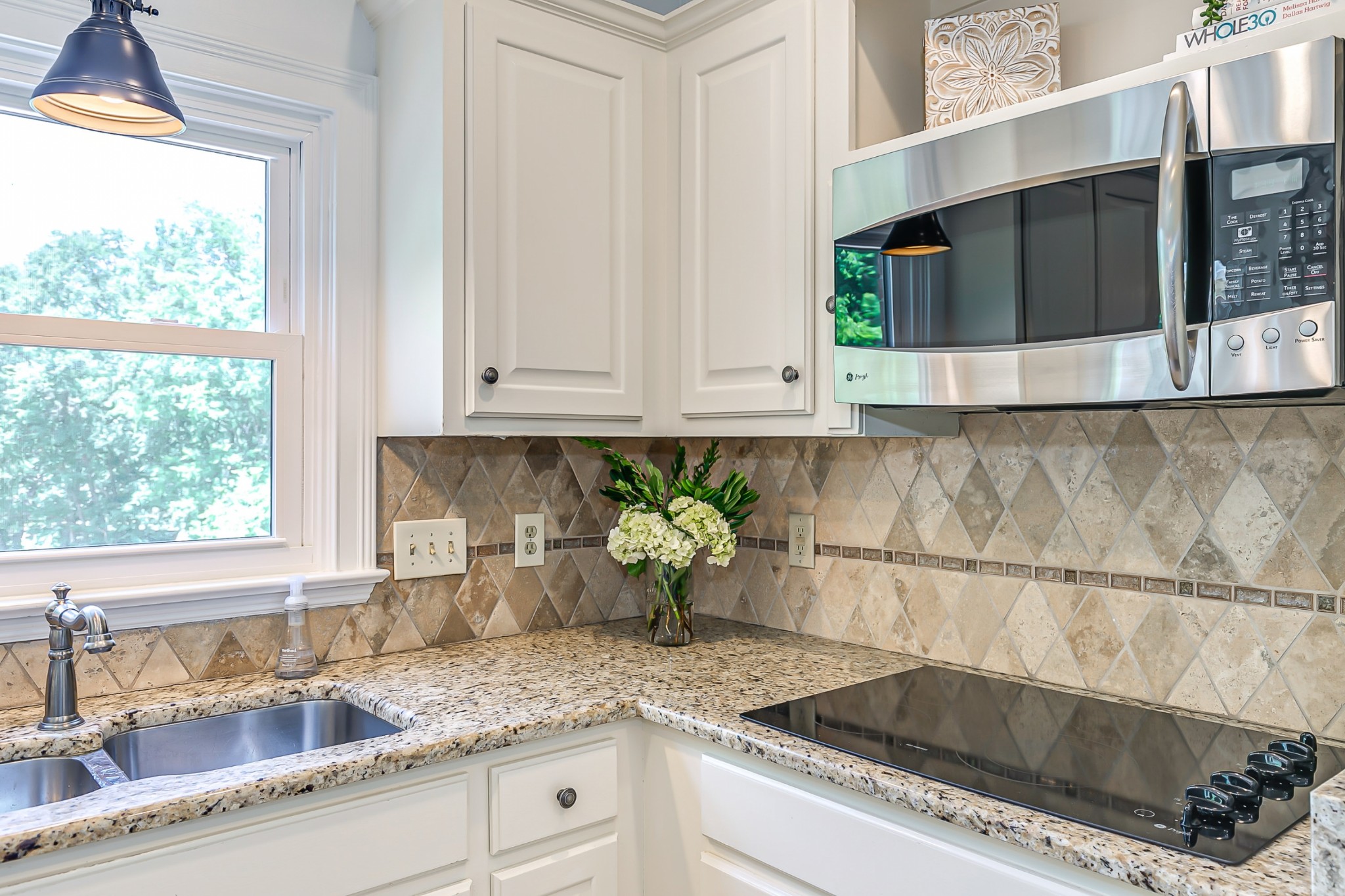 8204 Alamo Road Brentwood, TN 37027 - Photo 12 of 41 a kitchen with stainless steel appliances granite countertop a sink and a microwave
