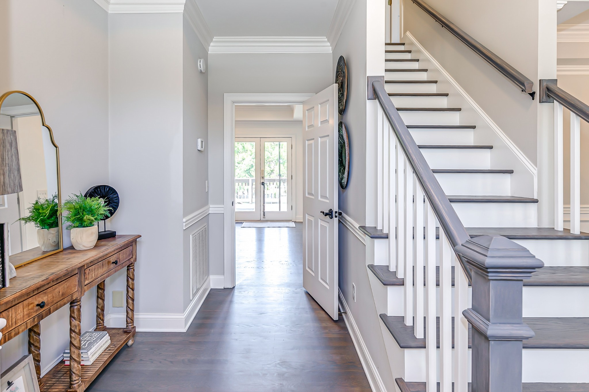 8204 Alamo Road Brentwood, TN 37027 - Photo 4 of 41 a view of a hallway with wooden floor and stairs