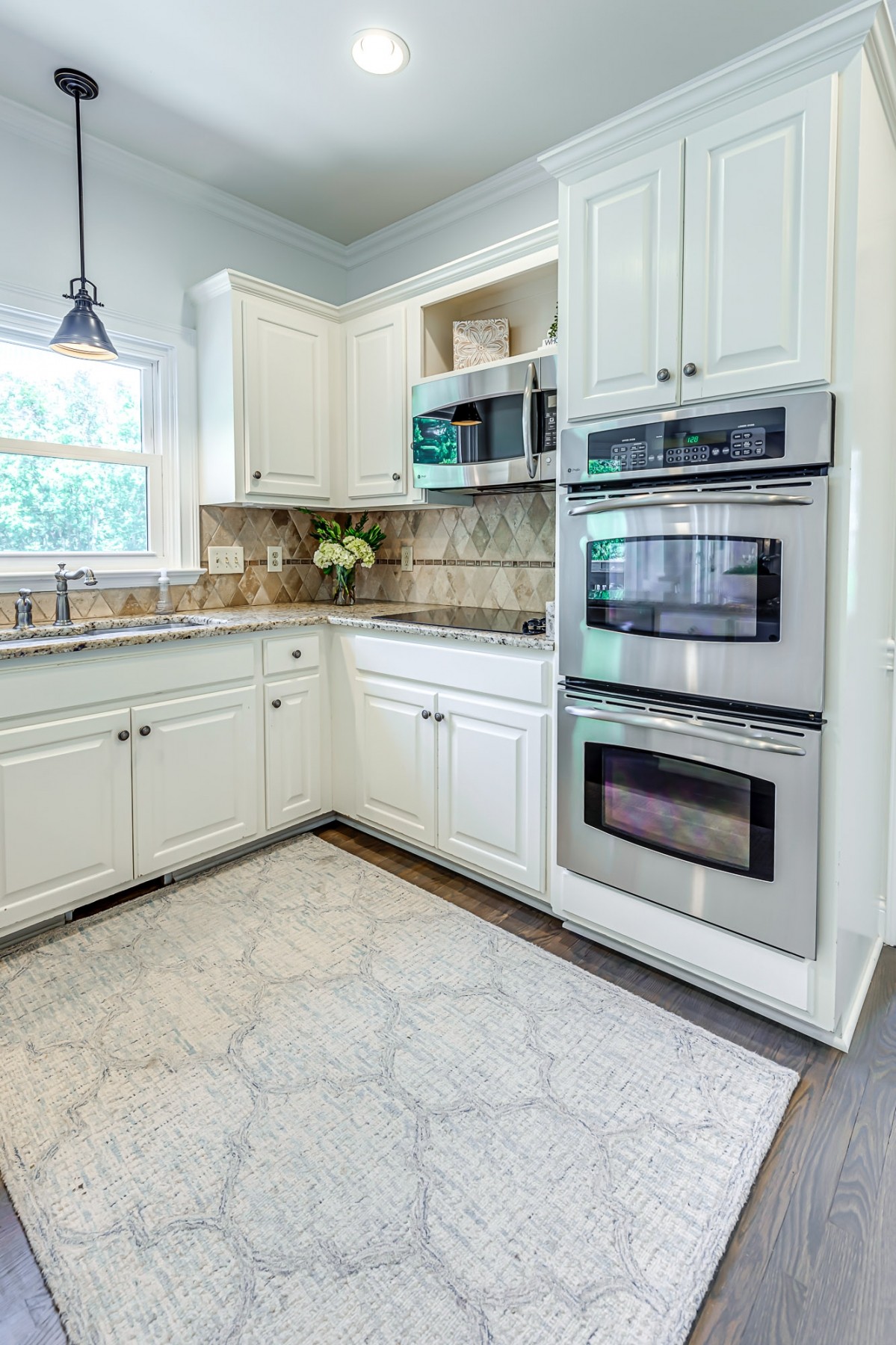 8204 Alamo Road Brentwood, TN 37027 - Photo 10 of 41 a kitchen with stainless steel appliances granite countertop a stove a sink and a microwave