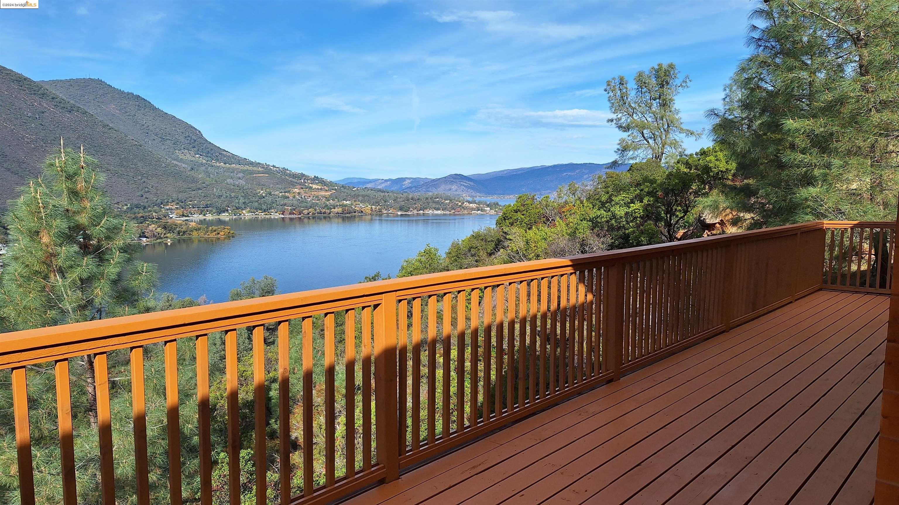 a balcony with wooden floor and mountain view