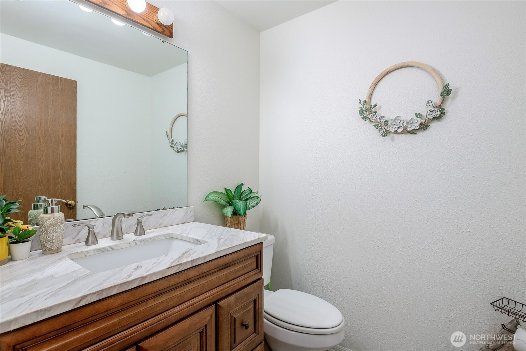 8903 216th St Court East Graham, WA 98338 - Photo 12 of 31 a bathroom with a granite countertop toilet a sink and mirror
