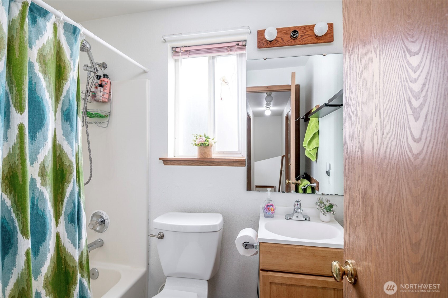 8903 216th St Court East Graham, WA 98338 - Photo 21 of 31 a bathroom with a sink mirror vanity and toilet
