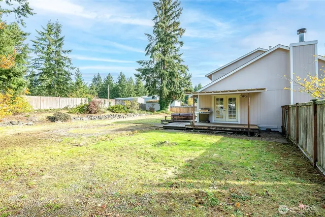 a view of a backyard with wooden fence