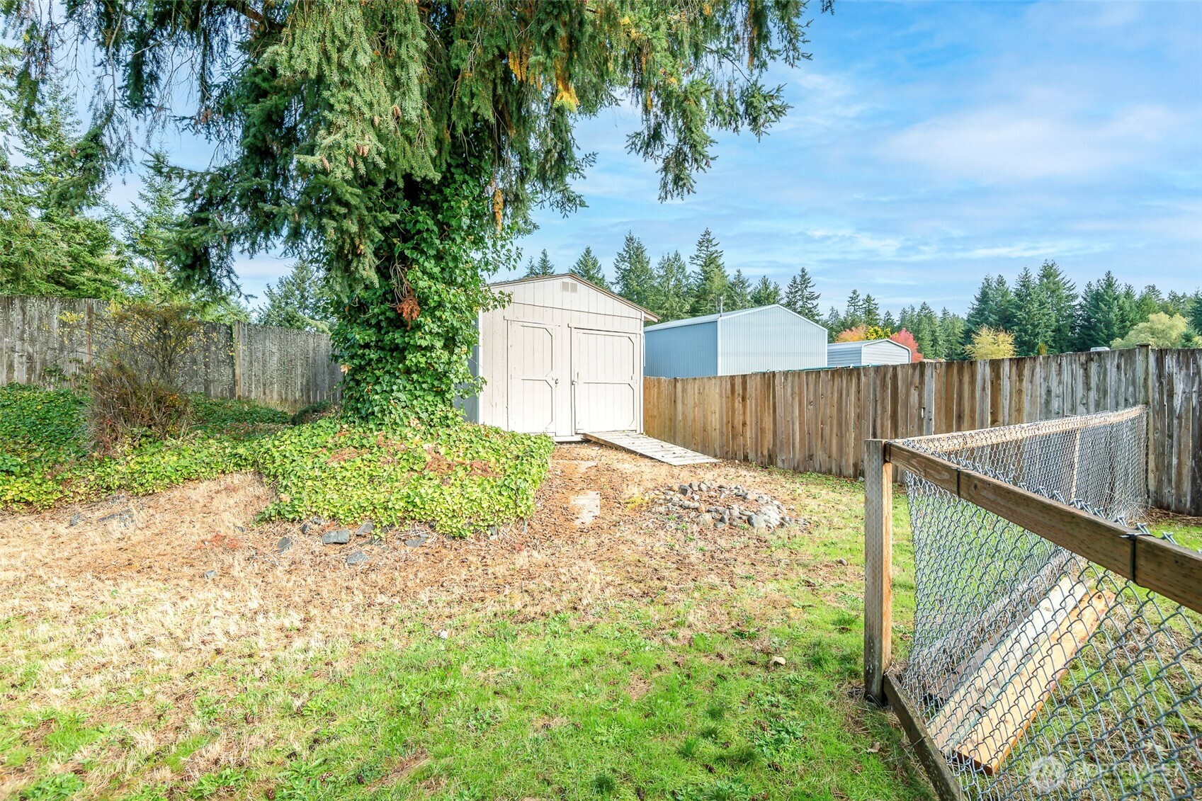 8903 216th St Court East Graham, WA 98338 - Photo 28 of 31 a view of a backyard with wooden fence