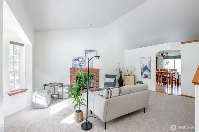 a living room with furniture and a potted plant
