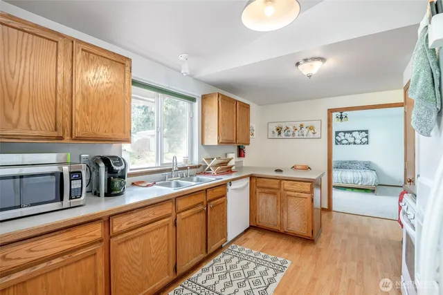 a kitchen with stainless steel appliances granite countertop a sink and cabinets