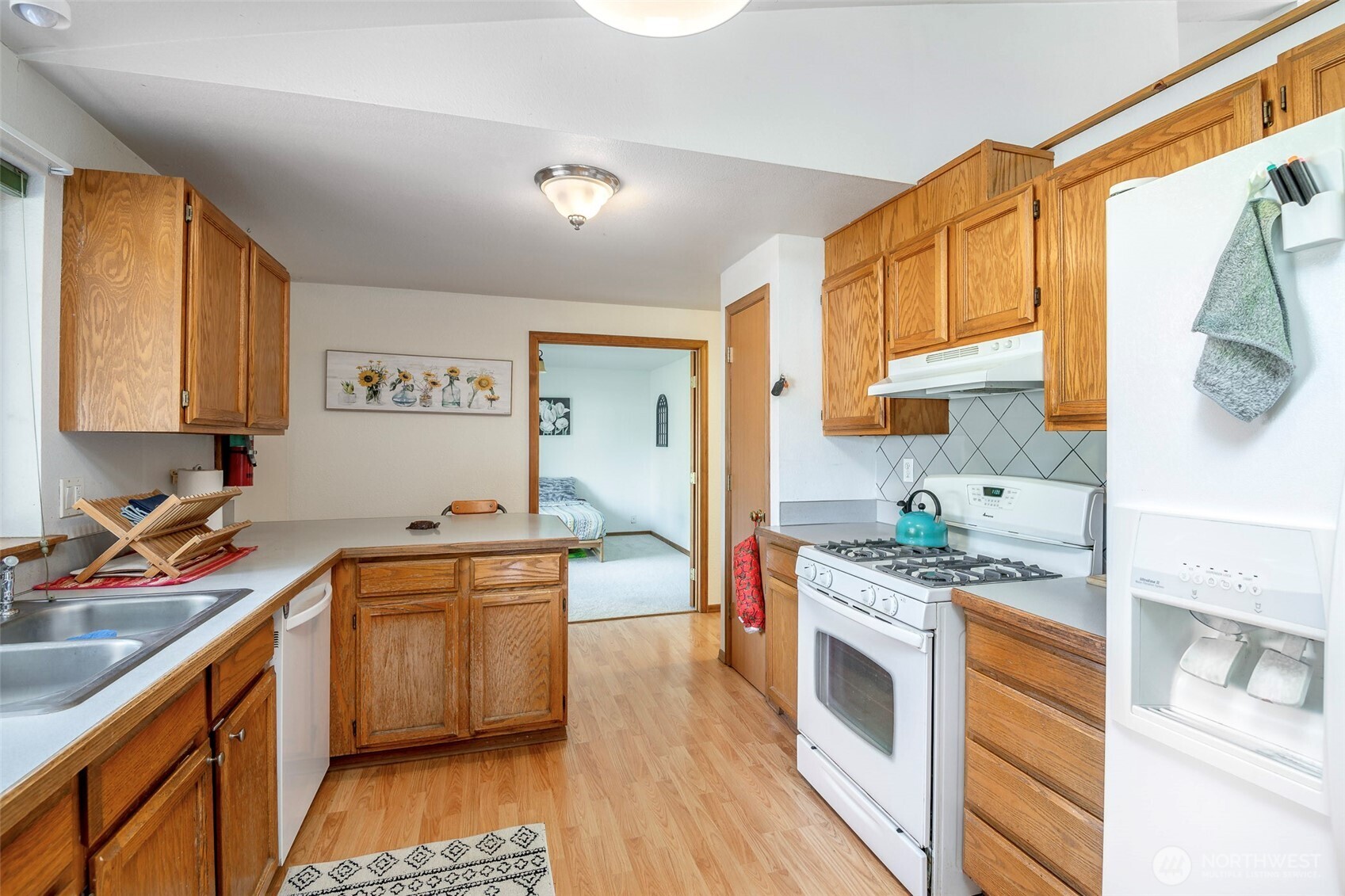 8903 216th St Court East Graham, WA 98338 - Photo 9 of 31 a kitchen with stainless steel appliances granite countertop a stove a sink and a refrigerator