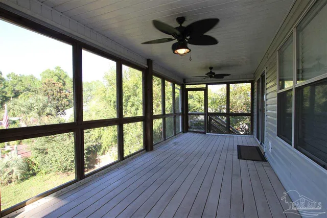 a view of big room with wooden floor and balcony