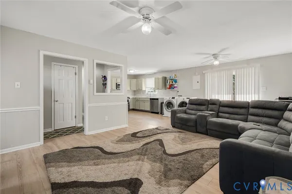 a living room with furniture and kitchen view