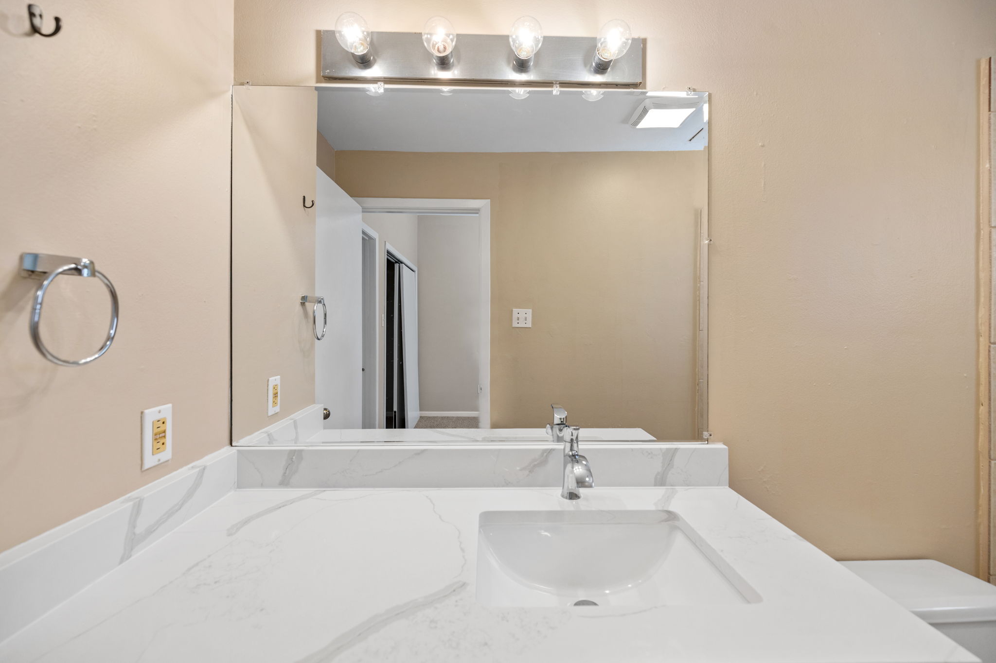 712 Graham Place, Unit 203 Austin, TX 78705 - Photo 24 of 30 a bathroom with a sink and a mirror