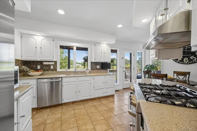 a kitchen with a stove a sink and a refrigerator