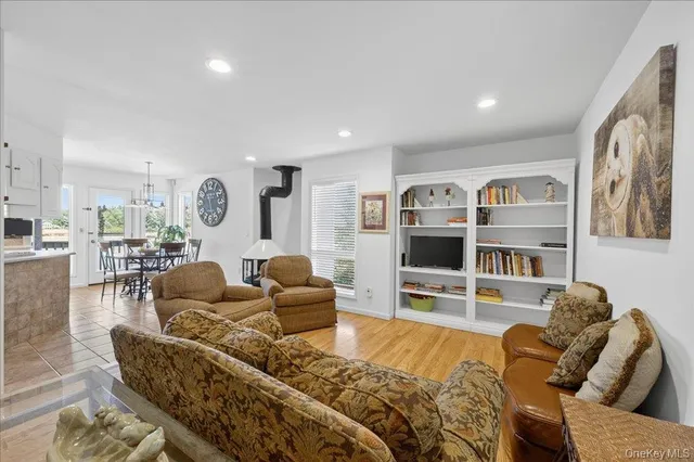 a living room with furniture and a view of kitchen