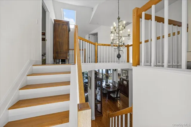 a bathroom with a sink a light fixture and a toilet