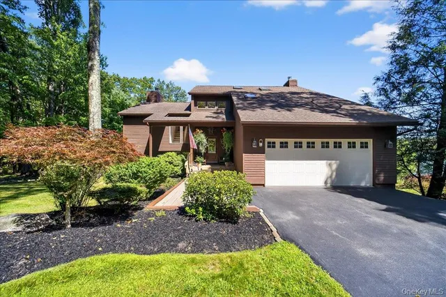 a front view of a house with a garden and plants