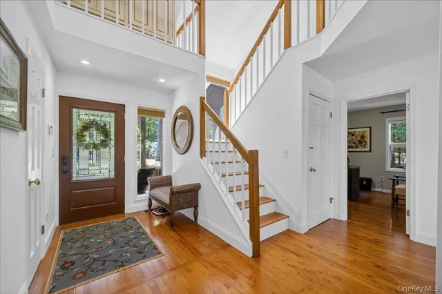 a view of entryway and hall with wooden floor