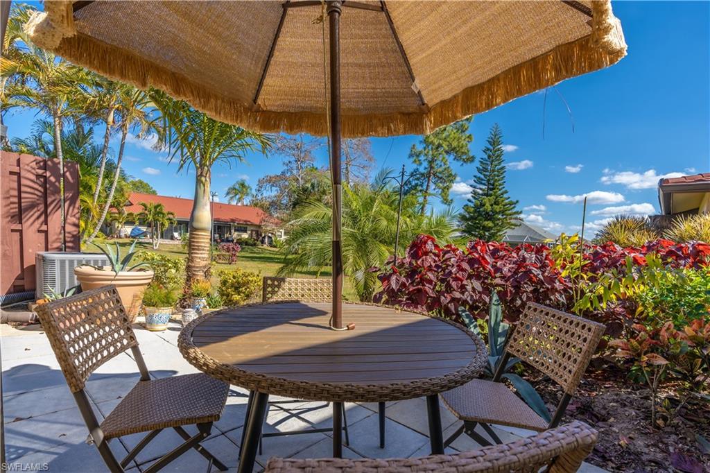 2048 Pine Isle Lane, Unit 2048 Naples, FL 34112 - Photo 30 of 50 a view of an outdoor sitting area with furniture